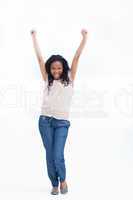 A young laughing woman stands with her arms held up in the air