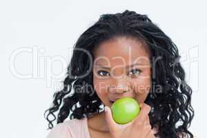 Head shot of a woman eating an apple