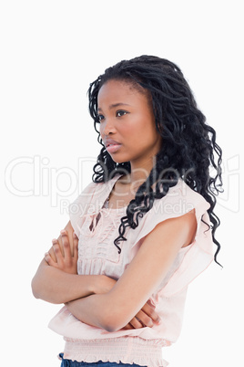 A worried looking girl with her arms folded