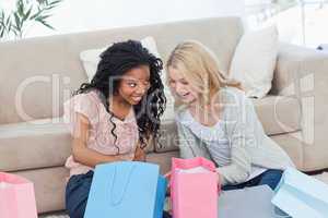 Two smiling women with shopping bags