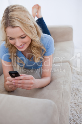 A woman is looking at her mobile phone