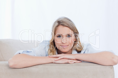 A woman with her arms resting is looking at the camera