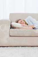 A woman is sleeping on a couch