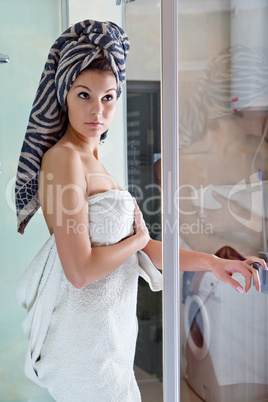 Beautiful girl after a shower in a white towel