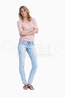 A woman standing with her arms folded