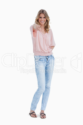 A smiling woman is pointing at the camera A smiling woman is pointing at the camera