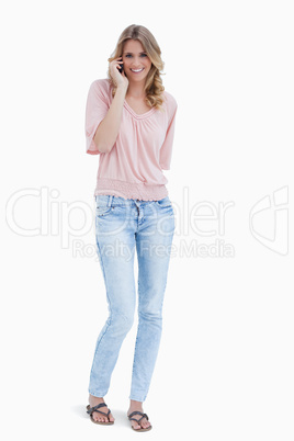 Full length shot of a smiling woman talking on her mobile phone