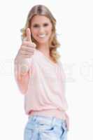 Focus shot of a woman with her thumb up