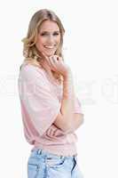 Smiling woman is resting her chin on her hand