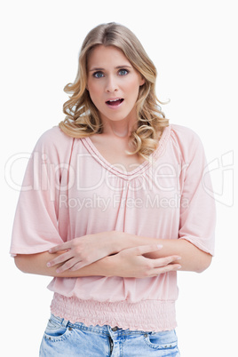 Woman with a shocked expression on her face has her arms crossed