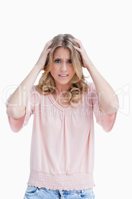 Frustrated woman has her hands held up to her head