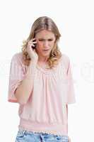 An angry woman is talking on her mobile phone