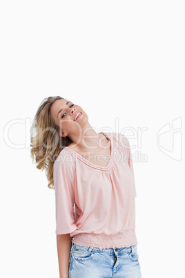 Smiling blonde woman holds her head back