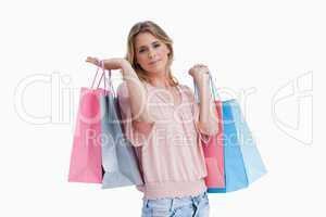 A woman carrying shopping bags over her shoulder