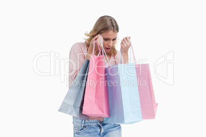 A woman is carrying shopping bags