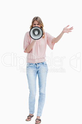 Young woman standing upright while using a megaphone