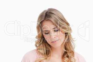 Calm young blonde woman looking down