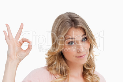 Relaxed young woman showing the ok sign