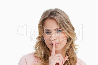 Serious young woman asking for silence