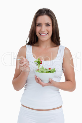 Smiling woman eating a salad