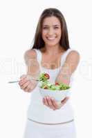 Delicious salad being eaten by a young woman