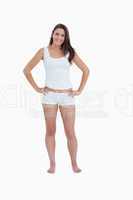 Smiling woman standing upright with her hands on her hips
