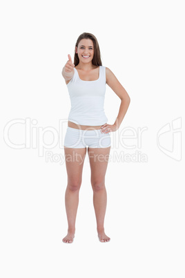 Happy brunette woman putting her thumbs up