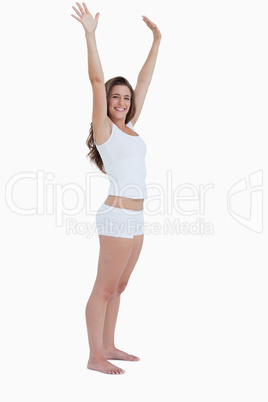 Smiling woman raising her arms above her head