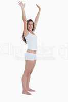 Smiling woman raising her arms above her head