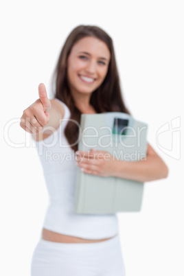 Thumbs up being placed by a brunette woman