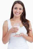 Smiling woman holding a glass of milk