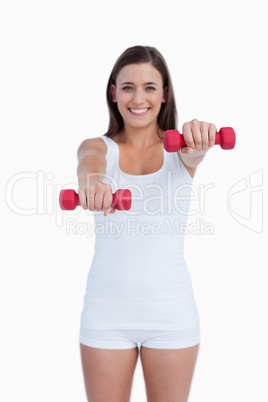 Red weights being held by a young brunette