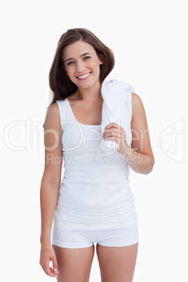 Smiling woman holding a white towel on her shoulder