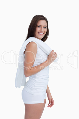 young smiling brunette holding a towel on her shoulder