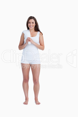 Young smiling brunette holding a towel