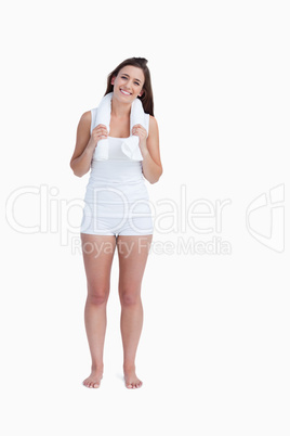 Young woman standing upright while holding a towel