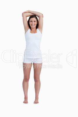 Smiling woman crossing her arms above her head