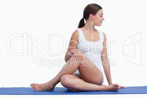 Young woman making exercises on her yoga mat