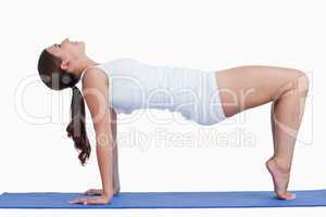 Young woman practicing yoga on a mat