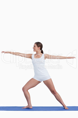 Smiling woman practicing yoga on a mat