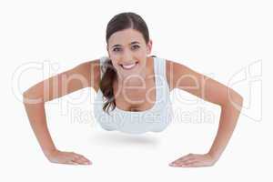 Smiling woman doing a push-up