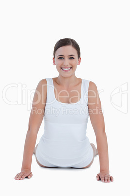 Smiling woman looking at the camera while doing exercises