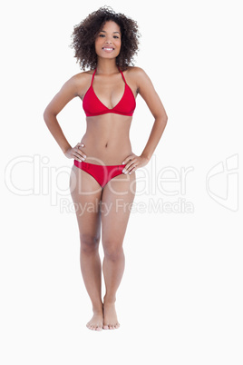 Smiling woman standing upright in swimsuit