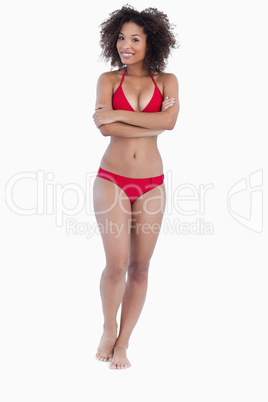 Smiling brunette standing upright in bikini