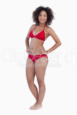 Smiling woman placing her hands on hips