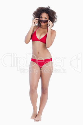 Young woman looking over her sunglasses