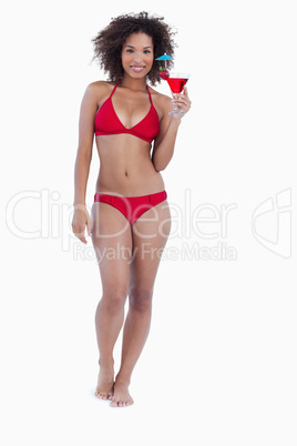 Smiling brunette holding an exotic cocktail