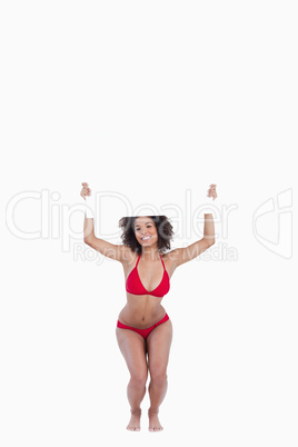 Smiling woman leaning forward while holding a blank poster