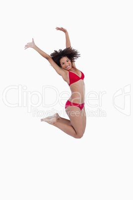 Side view of a young woman jumping