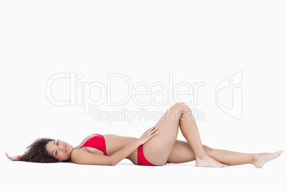 Attractive woman lying down while looking at the camera